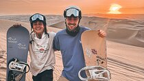 Sandboarding or Sandsky with sunset in Huacachina
