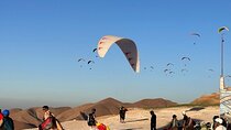 Fly over the mountains with paraglaiding experience